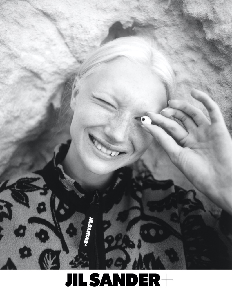 Evelina Lauren flashes a smile in Jil Sander+ spring-summer 2022 campaign.