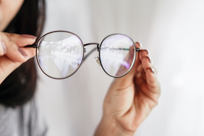 Woman Holding Round Glasses