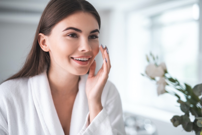 Woman Touching Skin Mirror