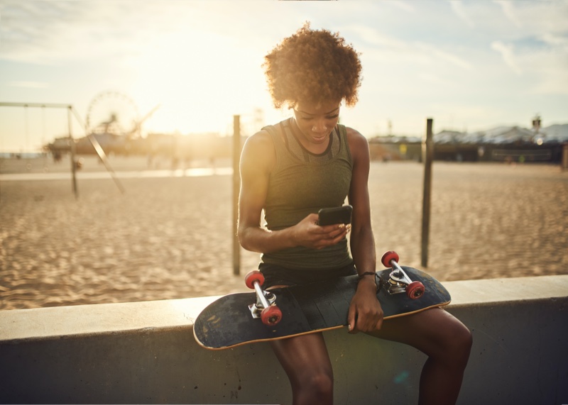 Black Woman Holding Skateboard Phone
