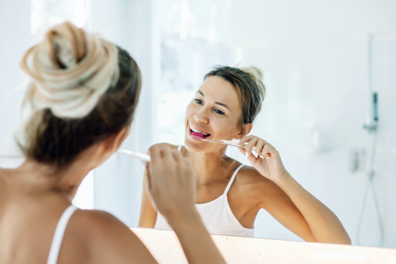 Woman Brushing Teeth Mirror