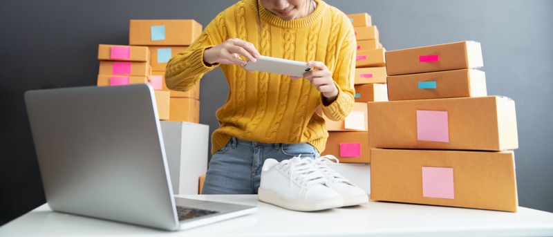 Woman Photographing Sneakers to Sell Online