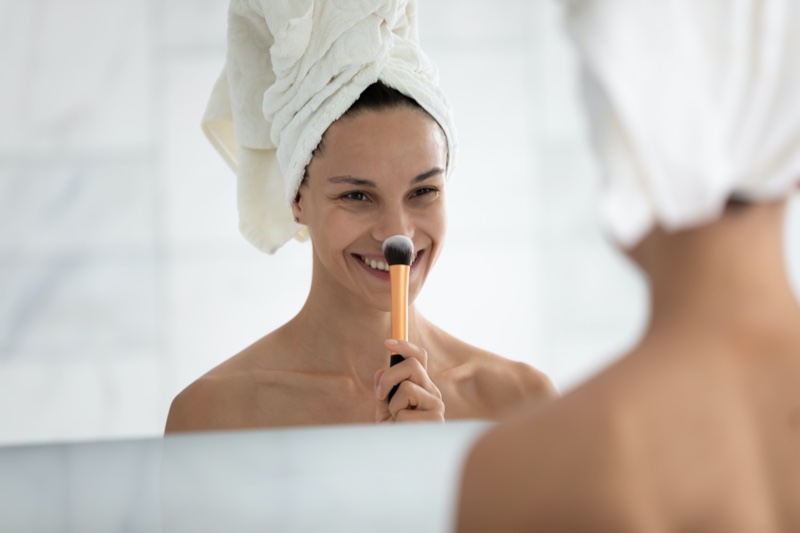 Woman with Makeup Brush Mirror