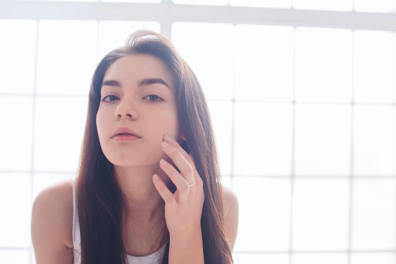 Young Woman Checking Face Mirror