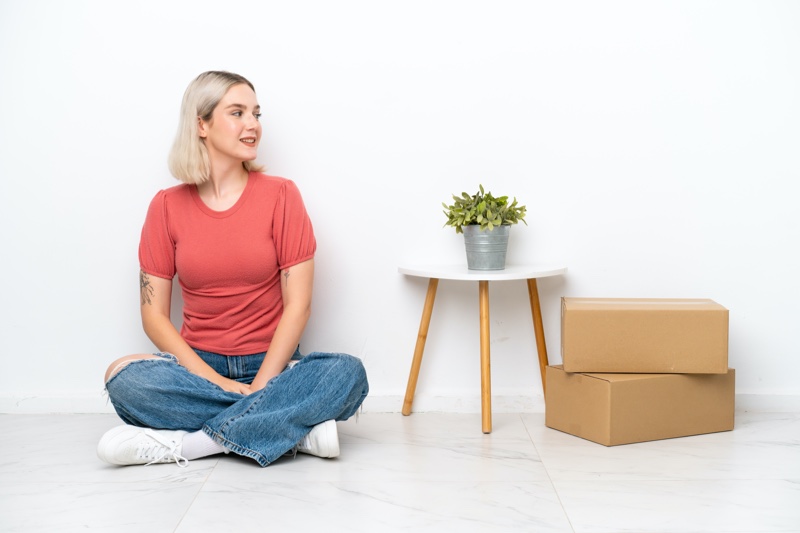 Young Woman Sitting Boxes Small Table