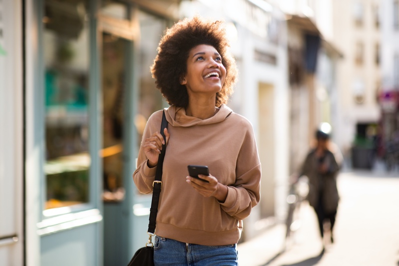 Black Woman Holding Phone Street