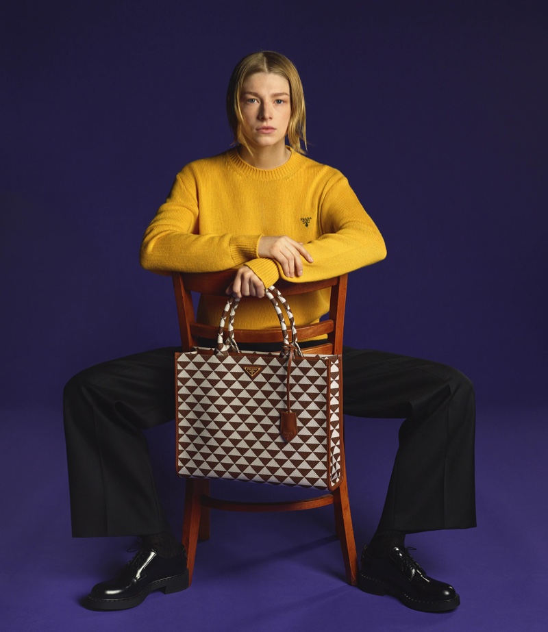 Taking a seat, Hunter Schafer appears in Prada Symbole handbag campaign.