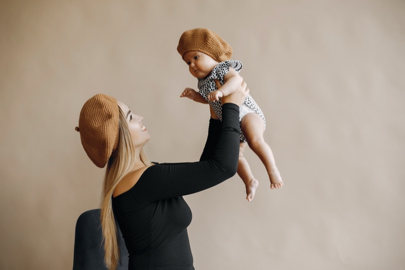 Mom Holding Up Baby Girl Beret Stylish