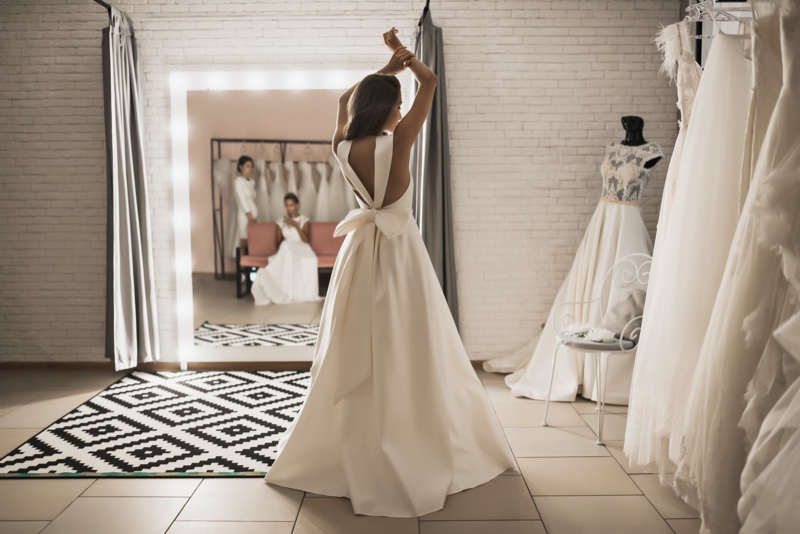 Woman Trying on Wedding Dresses