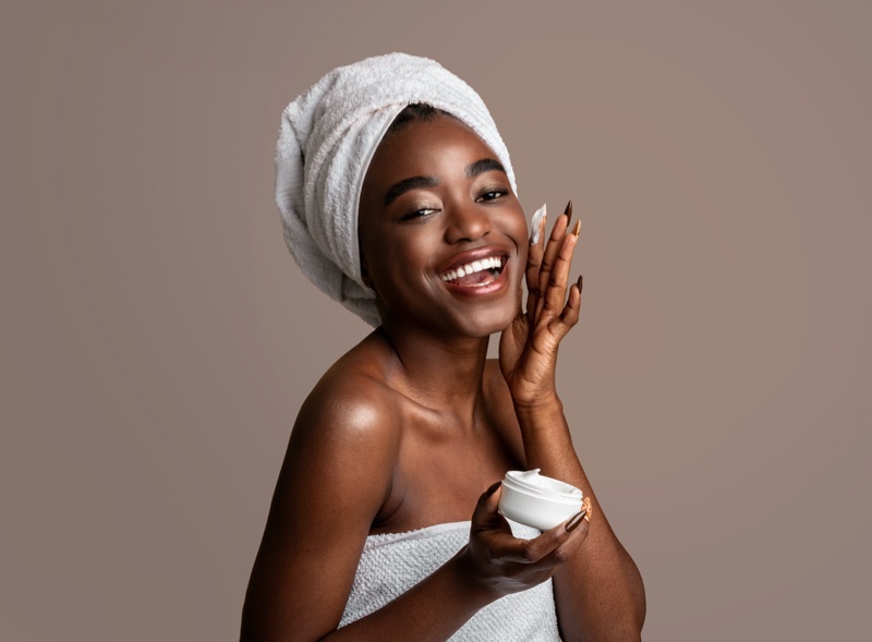 Black Model Applying Skin Moisturizer