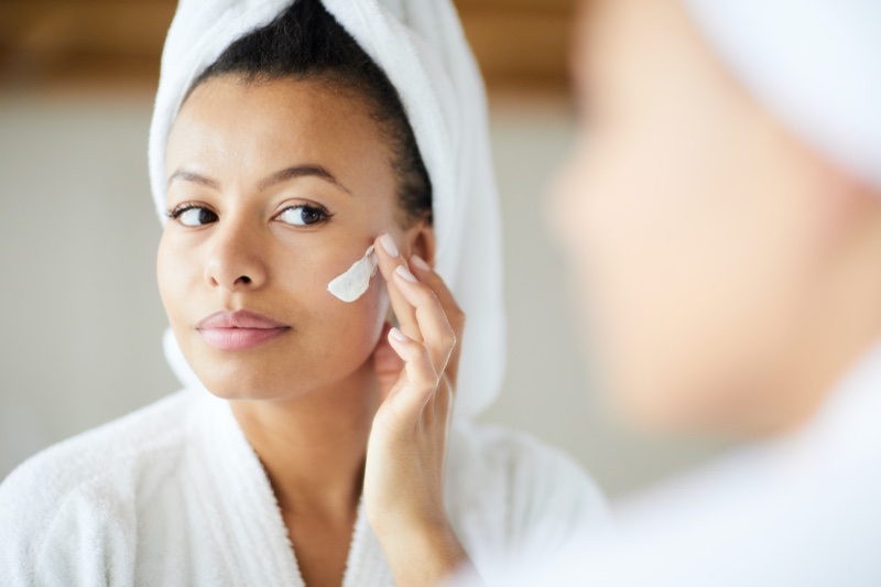 Black Woman Applying Moisturizer Face