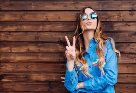 Model Throwing Peace Sign Sunglasses Blue Shirt