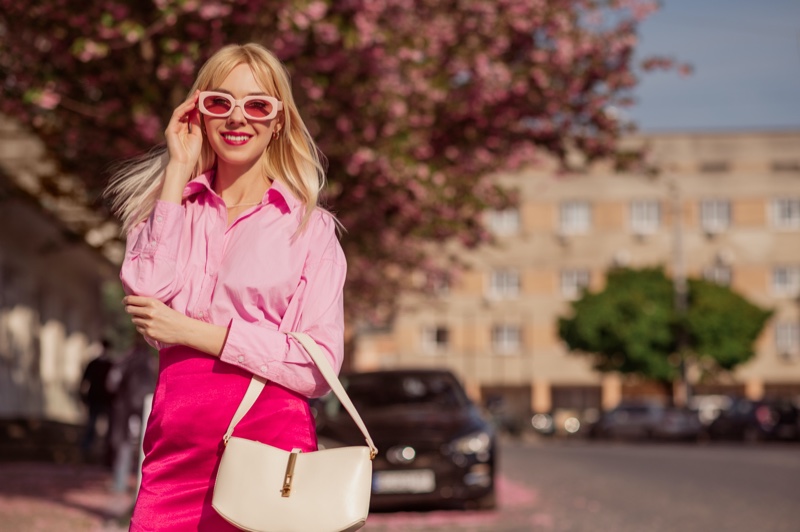 Smiling Model Pink Outfit Sunglasses Shirt Skirt Bag