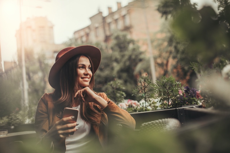 Woman Holding Phone Posing Hat