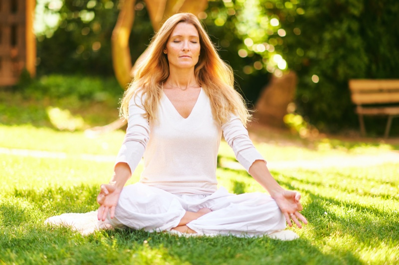 Older Woman Meditating Outside