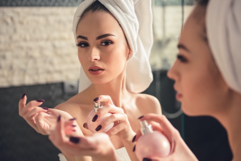 Woman Beauty Spraying Perfume Mirror