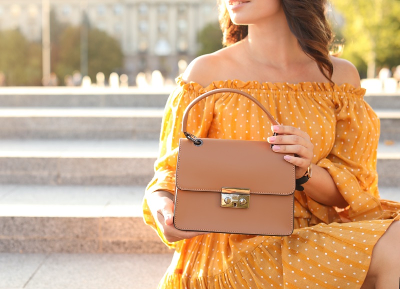 Woman Yellow Dress Holding Beige Handbag