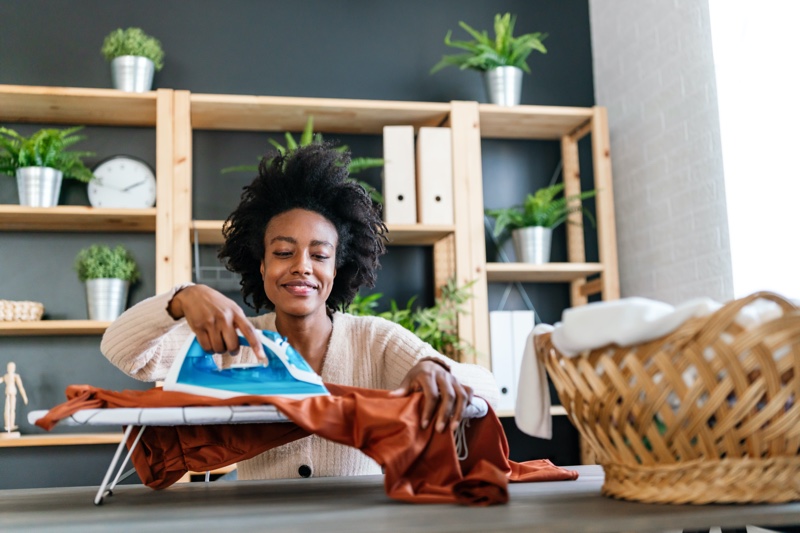 Black Woman Ironing Clothes Home