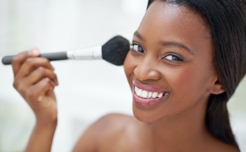 Black Woman Smiling Applying Makeup