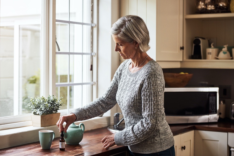 Older Woman Kitchen CBD Oil