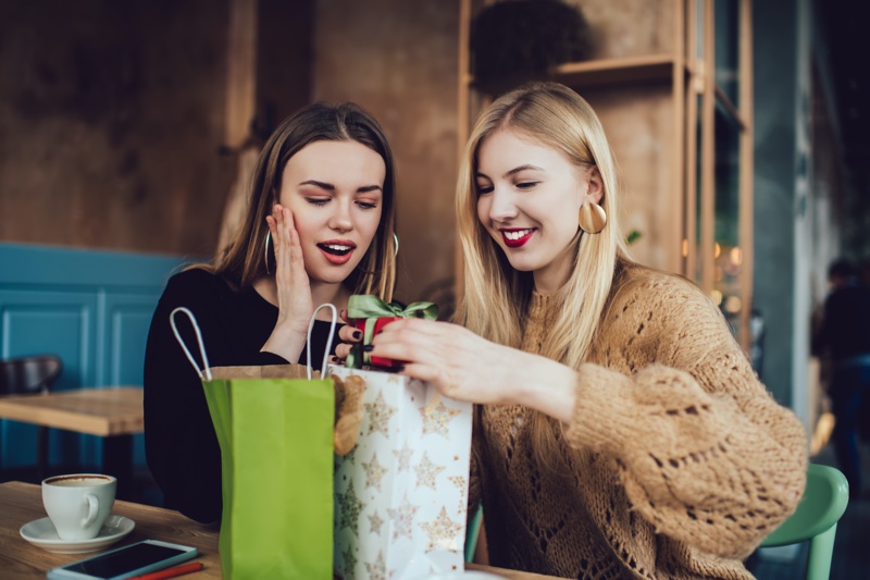 Two Girlfriends Exchanging Gifts