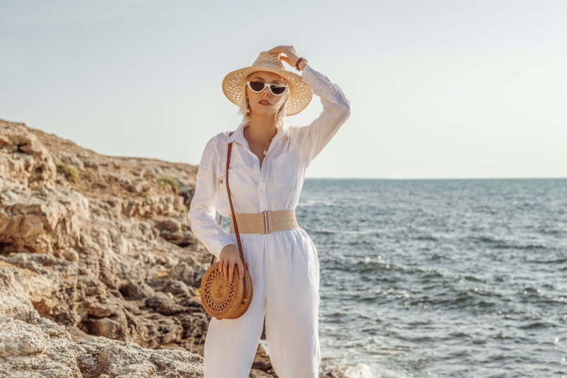 Woman White Jumpsuit Hat Water Bag