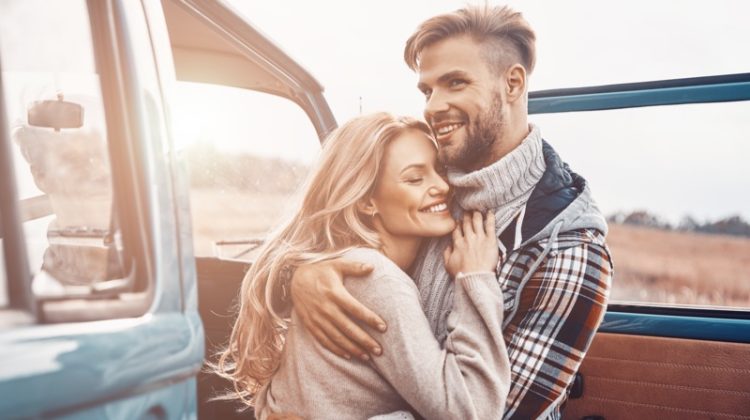Happy Couple Hugging Van