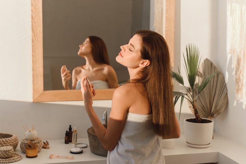 Woman Applying Perfume Bathroom Mirror