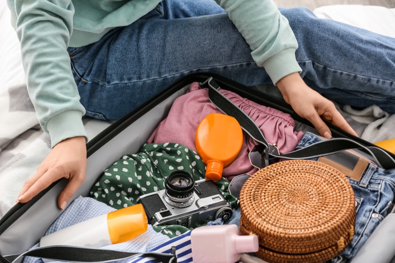 Woman Packing Suitcase Toiletries Bag