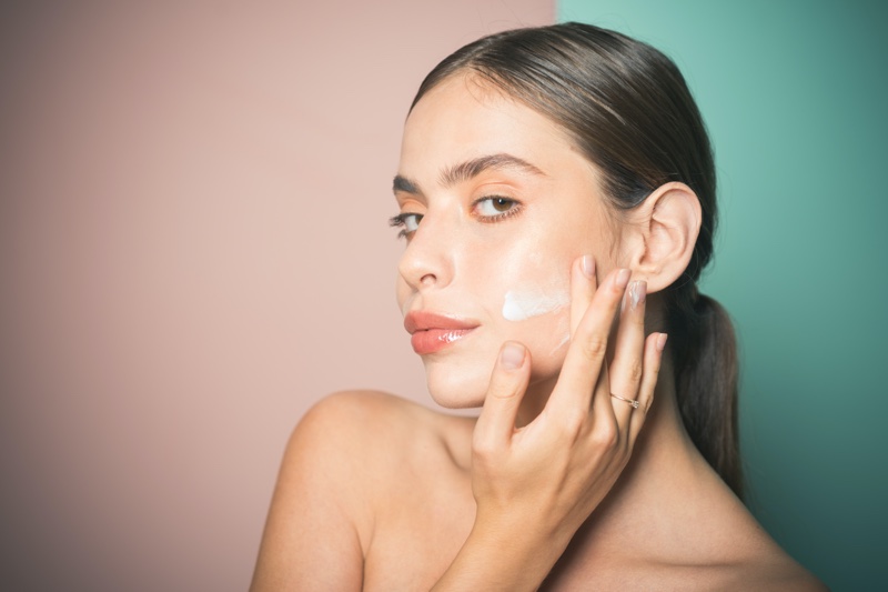 Model Applying Facial Moisturizer