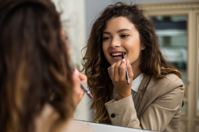 Woman Applying Lip Liner Mirror