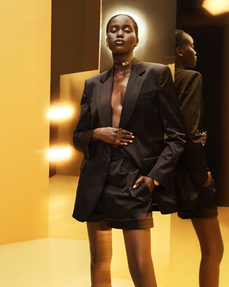 Adut Akech wears black jacket and shorts in BOSS Holiday 2022 campaign.