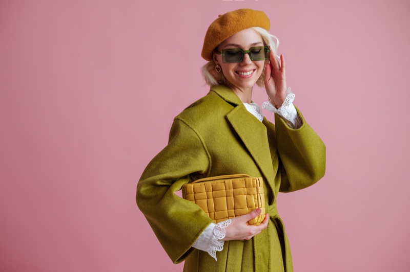 Model Smiling Green Coat Yellow Bag Beret