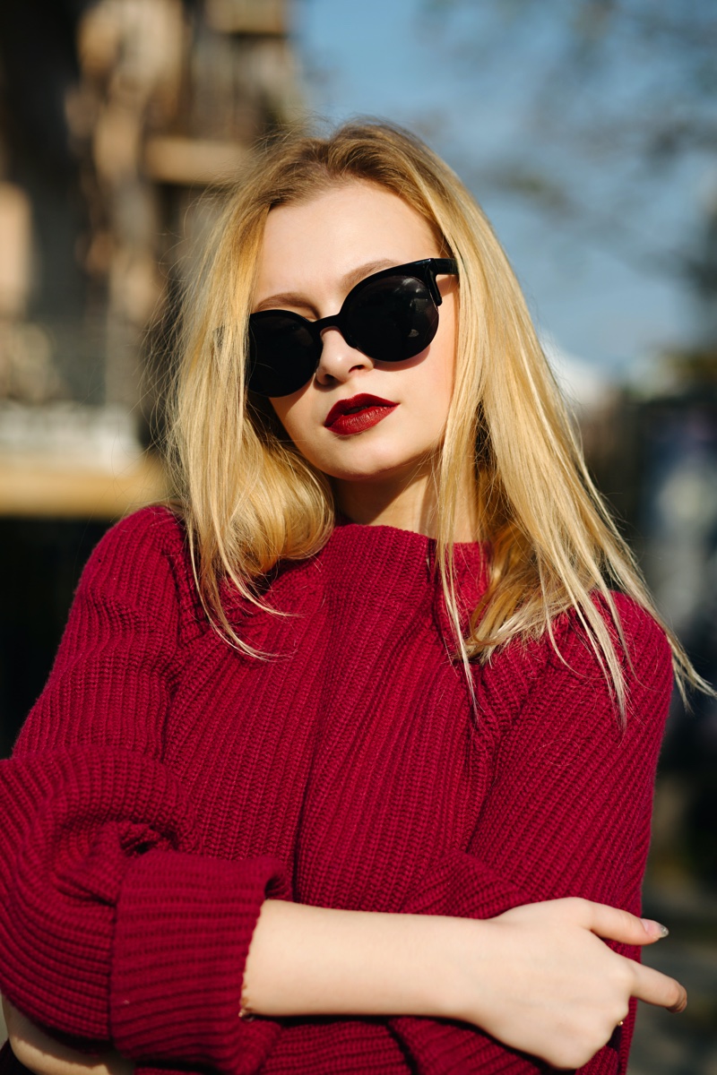 oversized sunglasses red sweater woman
