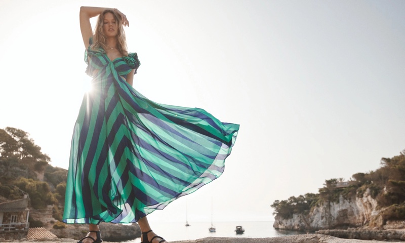 Embracing stripes, Anna Ewers wears Tiggy frill shoulder striped maxi dress from Zimmermann's Resort Swim 2023 collection.