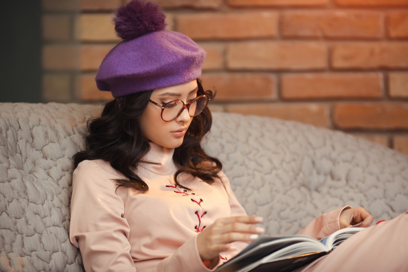 asian woman reading book glasses fashionable