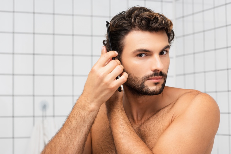 attractive guy combing hair