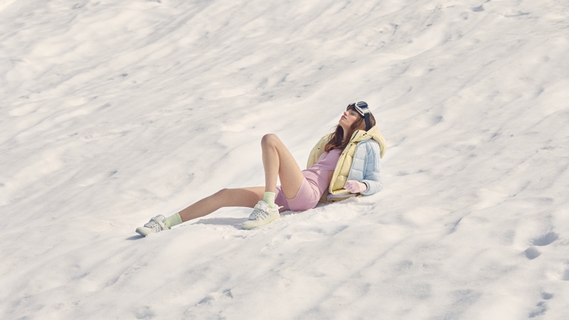 A model poses in the snow for Bad Bunny x adidas Originals Last Forum sneaker.
