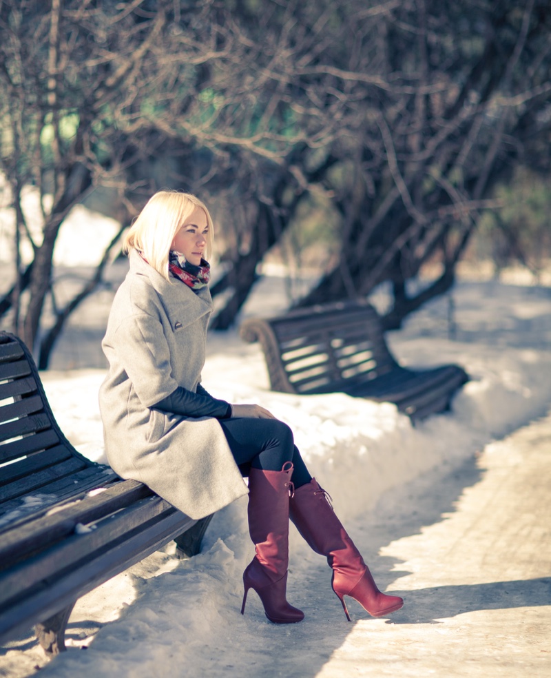 bench woman coat boots snow