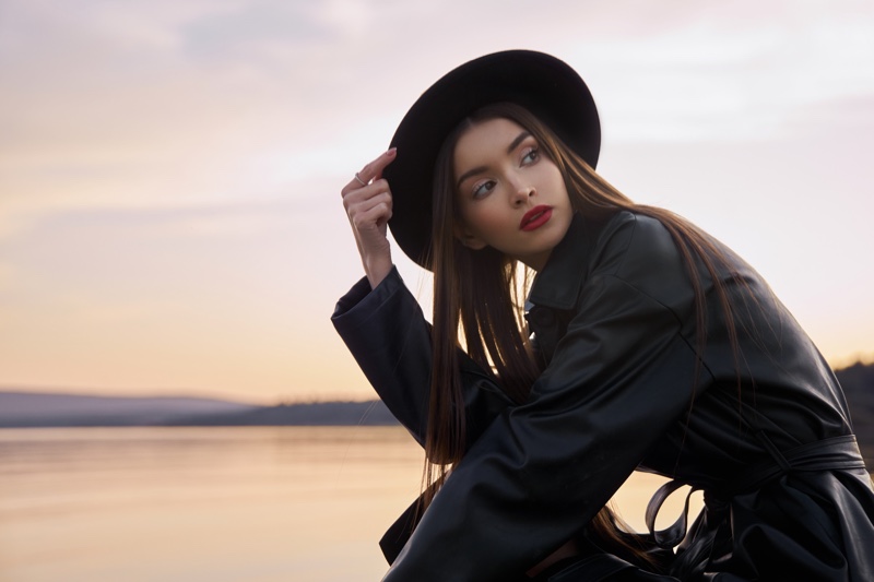 black leather coat hat outdoors red lip