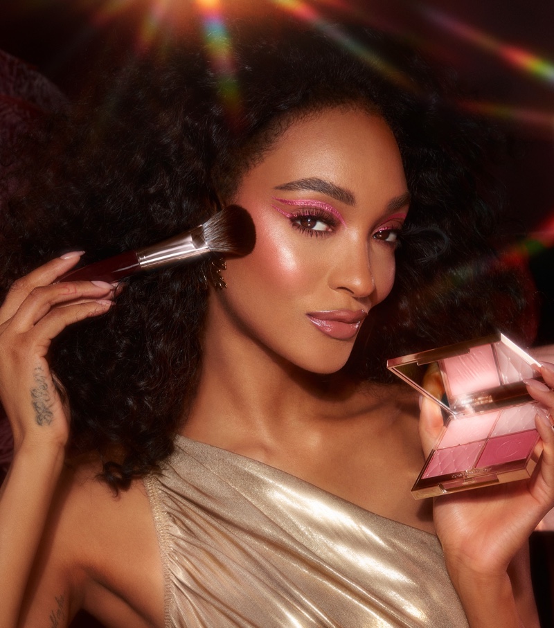 Jourdan Dunn poses with Pillow Talk Beautifying Face Palette for Charlotte Tilbury Holiday 2022 campaign.