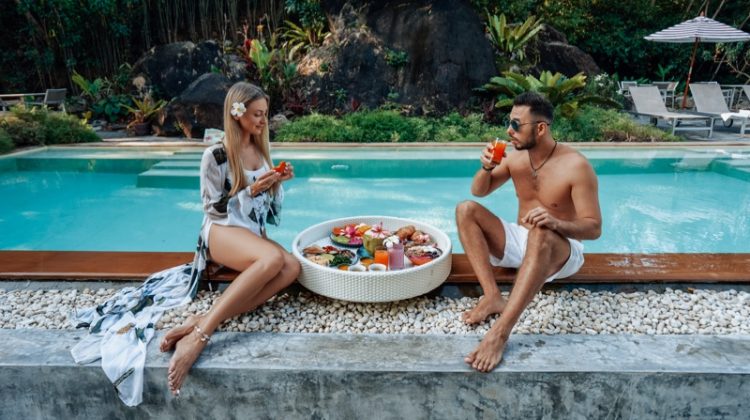 couple pool eating honeymoon travel