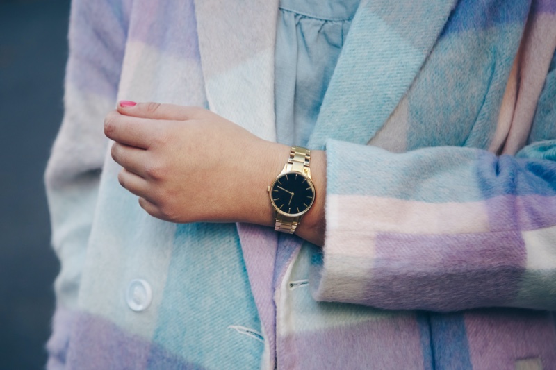 cropped woman plaid coat gold watch
