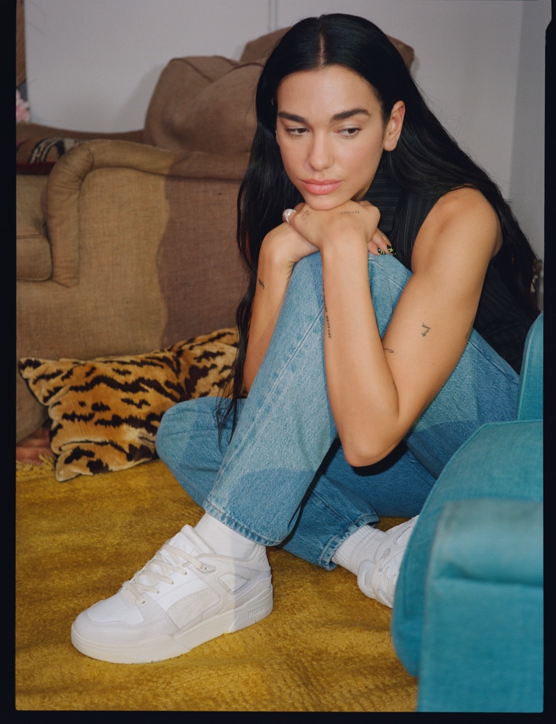 Posing in jeans, Dua Lipa fronts PUMA Thrifted Pack campaign.