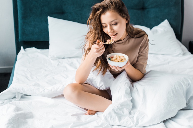 eating bowl oatmeal bed woman