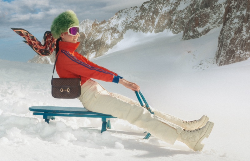 A model goes sledding in Gucci Après-Ski 2022 collection.
