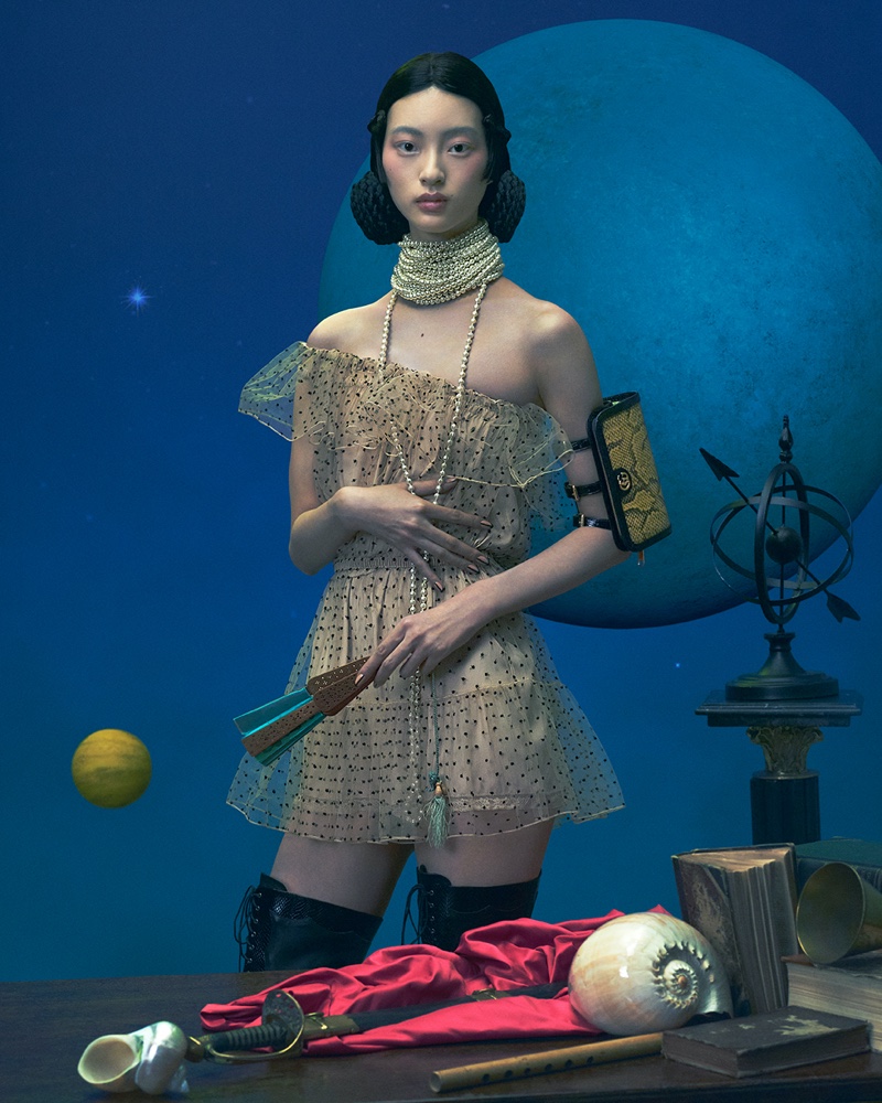 Draped in pearls, a model fronts Gucci Cosmogonie Cruise 2023 campaign.