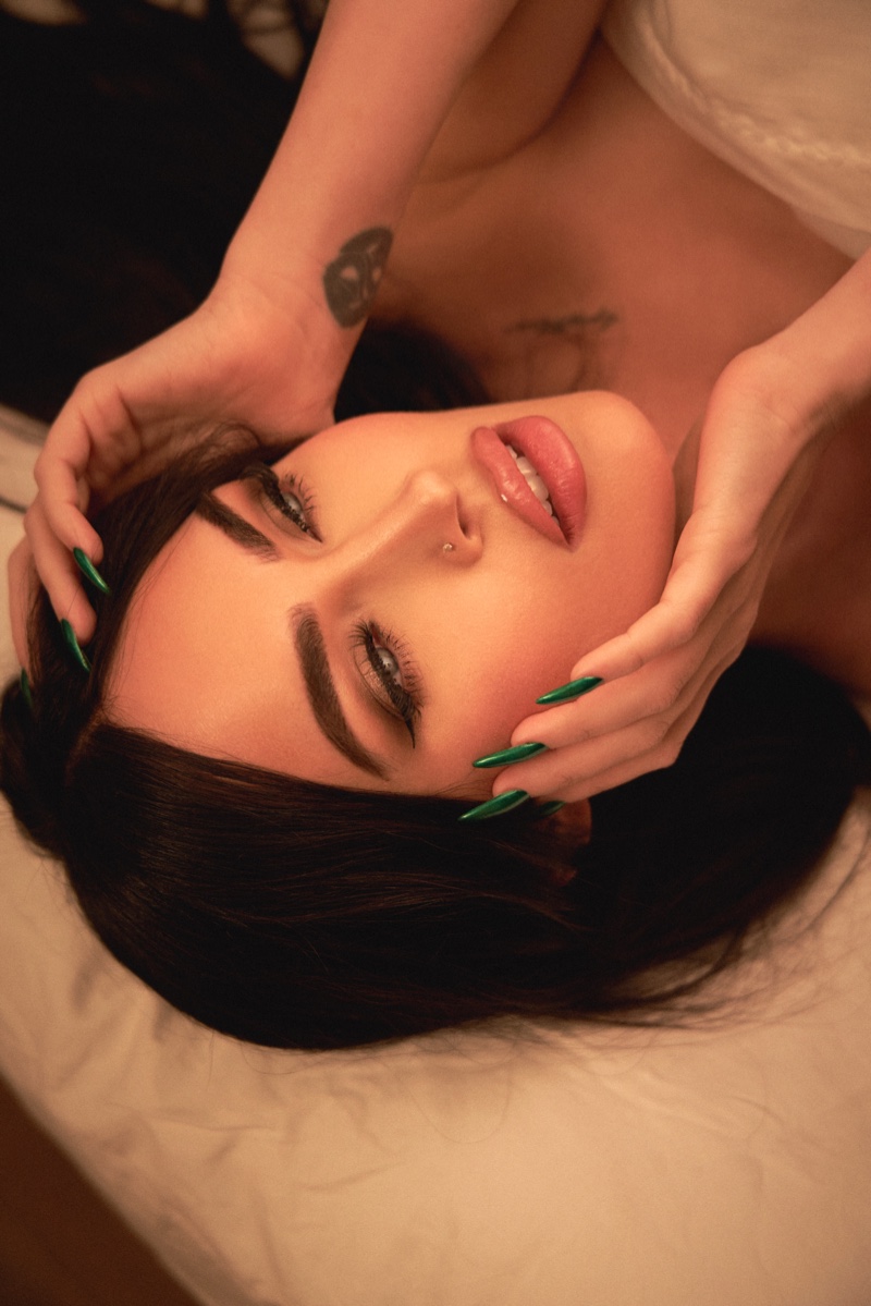 Megan Fox wears a bright green nail polish from her collaboration with UN/DN LAQR.