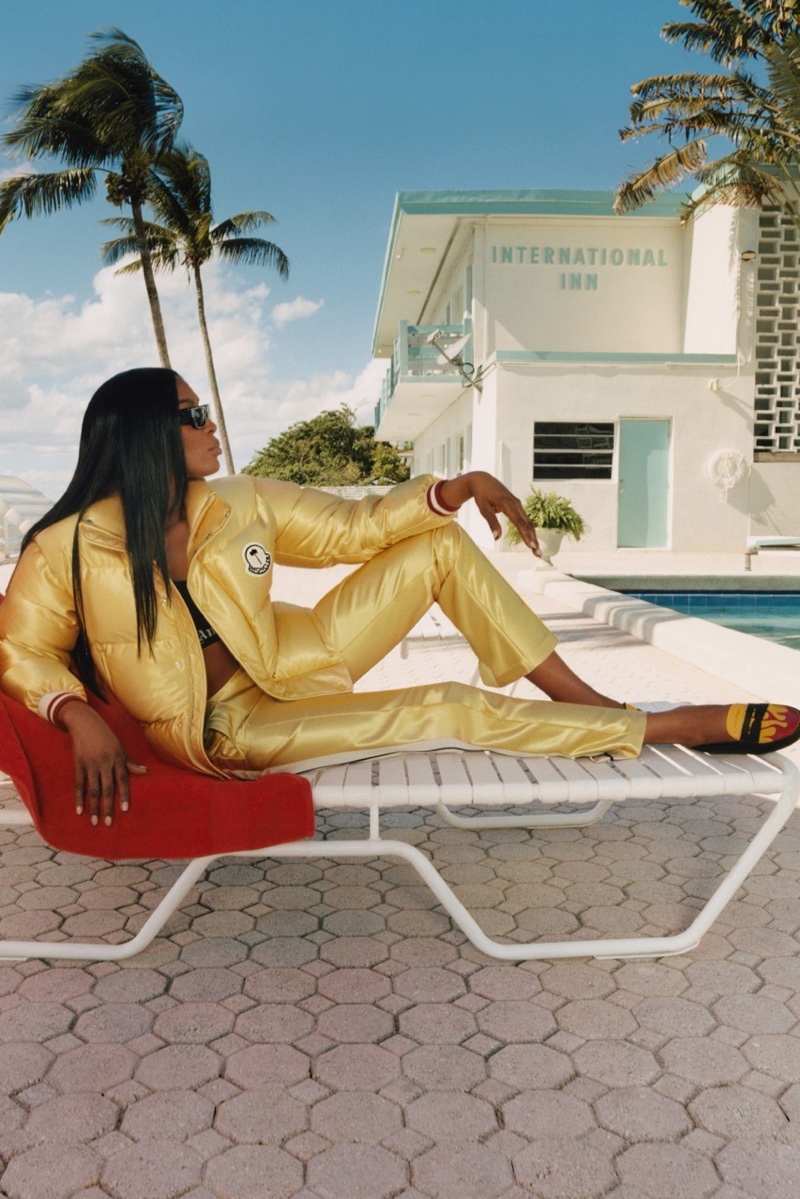 Dressed in gold puffer jacket and pants, Naomi Campbell fronts Tod’s x 8 Moncler Palm Angels campaign.