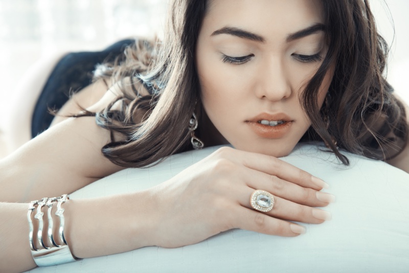 woman silver jewelry ring bracelet bed